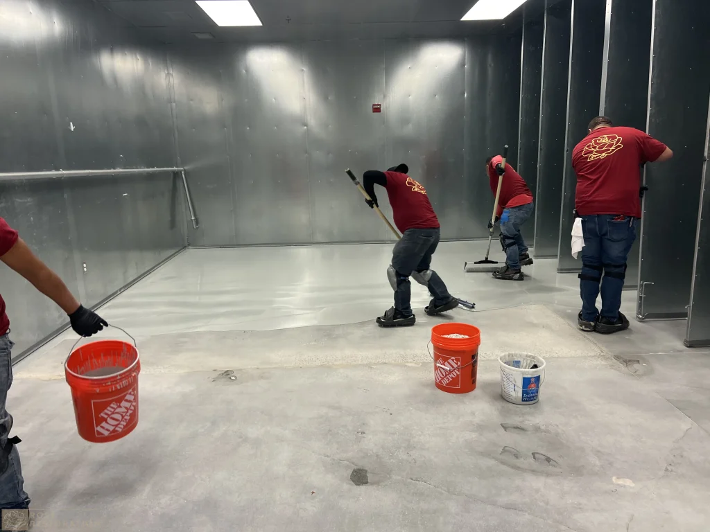 Crew applying an epoxy floor in a commercial space