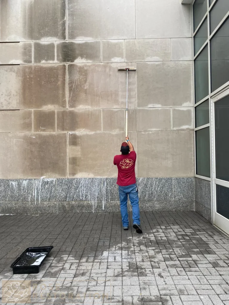 Technician cleaning a building facade.